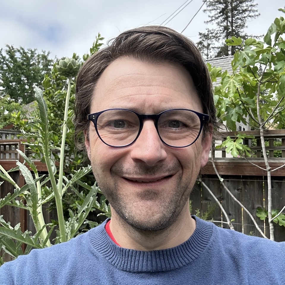 James, smiling in his garden next to artichokes and figs